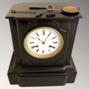 A black slate eight day mantel clock with enamel dial, with pendulum and key, height 27 cm.