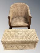 A wooden framed wicker armchair and a wicker hamper.