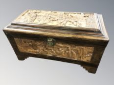 An oriental carved camphor wood blanket box, 76 cm x 38 cm x 42 cm.