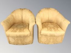 A pair of early 20th century armchairs in golden upholstery,