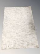 A modern machine made rug on green ground,