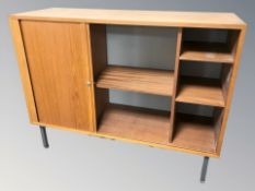 A 20th century teak sliding door office cabinet, 120 cm W x 45 cm D x 92 cm H.