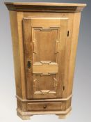 A Danish panelled blonde oak corner cabinet, height 147 cm.