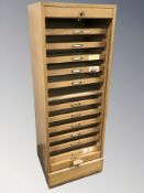 An early 20th century oak tambour front pedestal filing cabinet with key,