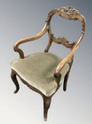 A walnut open armchair on cabriole legs.