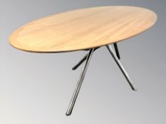 A contemporary teak oval dining table on chrome metal support, 200 cm L x 90 cm W x 73 cm H.