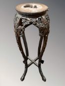 A 19th century Chinese carved hardwood and marble inset plant stand, height 92 cm.
