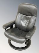A pair of Norwegian Ekornes stressless black stitched leather swivel armchairs, width 75 cm.