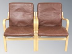 A pair of late 20th century Danish Stouby bentwood framed armchairs with terracotta leather