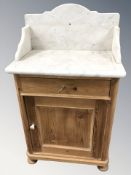 An early 20th century pine marble topped wash stand, 63 cm W x 42 cm D x 100 cm H.