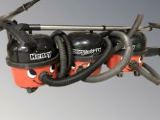 Three Henry vacuum cleaners.