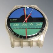 A quartz wall clock in the form of a swatch watch, width 30 cm.