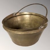 A brass swing handled cooking pot, height 21 cm excluding handle.