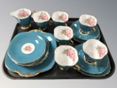 Twenty pieces of Windsor bone tea china on blue ground, decorated with roses.