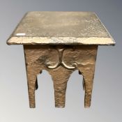 An Arts and Crafts hammered and copper plated metal miniature table, height 30 cm.