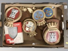 A group of ceramic Royal Navy warship crests on wooden shields