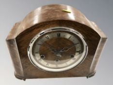An Art Deco oak eight day mantel clock, with pendulum and key, height 23 cm.