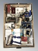 A box of mixed costume jewellery including earrings, pendants, cufflinks, wristwatches, pens, etc.
