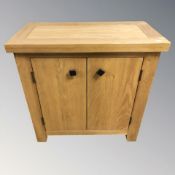 A modern oak double door cabinet, 70 cm x 35 cm x 70 cm.
