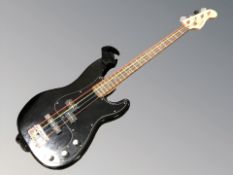 A Squier by Fender precision bass guitar.
