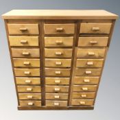 A 20th century pine twenty seven drawer chest, 90 cm W x 33 cm D x 108 cm H.