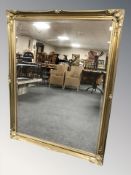 A reproduction gilt bevelled over mantle mirror,