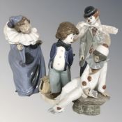 A Lladro clown violinist No. 5472 and three further Nao figures.