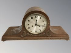 An early 20th century carved oak eight day mantel clock, width 61 cm.