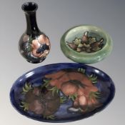 A Moorcroft vase, height 16 cm, a shallow bowl and a further oval plate.