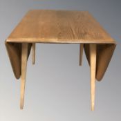 An Ercol elm and beech drop leaf dining table,