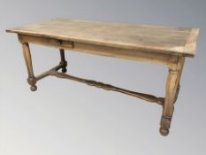 An early 20th century inlaid pine refectory table fitted a drawer,