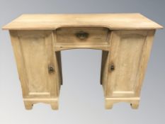 An early 20th century pine twin pedestal dressing table, 118 cm W x 48 cm D x 85 cm H.