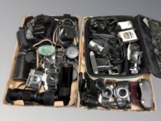 A collection of vintage and modern cameras including Olympus, Nikon, various lenses, camera bags,