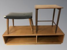 A teak low entertainment stand, width 117 cm, a stool and an occasional table.