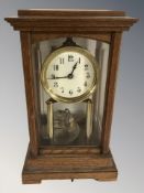 An oak-cased four-glass Gustav Becker torsion mantel clock, with key, height 32 cm.