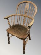 A 19th century elm spindle backed Windsor armchair,