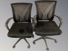 A pair of swivel armchairs