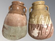 Two large earthen ware twin handled vessels,