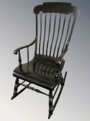 An early 20th century ebonised spindle backed rocking chair