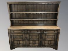 A reproduction oak dresser, 182 cm W x 47 cm D x 173 cm H.
