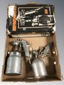 A boxed spray gun plus two others.