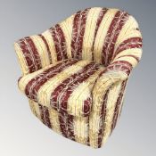 A 20th century armchair in striped classical upholstery,