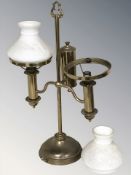 A brass twin branch table lamp with opaque glass shade, height 52 cm.