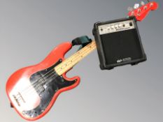 A bass guitar (as found) and an Acoustic Solutions mini amplifier with lead.