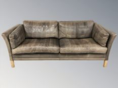 A late 20th century Danish three seater settee in faded brown leather, 189 cm L x 74 cm D x 81 cm H.
