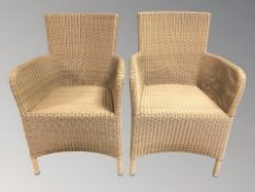 A pair of wicker armchairs,