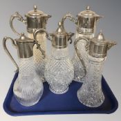Five pressed glass and EPNS mounted ewers, tallest 36 cm.