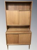 A 20th century Danish teak bookcase with sliding cabinet doors, 90 cm W x 44 cm D x 175 cm H.
