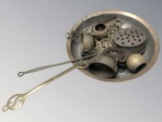 A copper pan together with other brass ware, roasting pan, horse brass, etc.