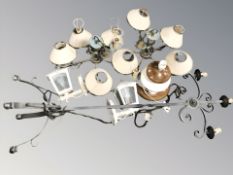 A wrought metal standard lamp, a pair of brass chandeliers,